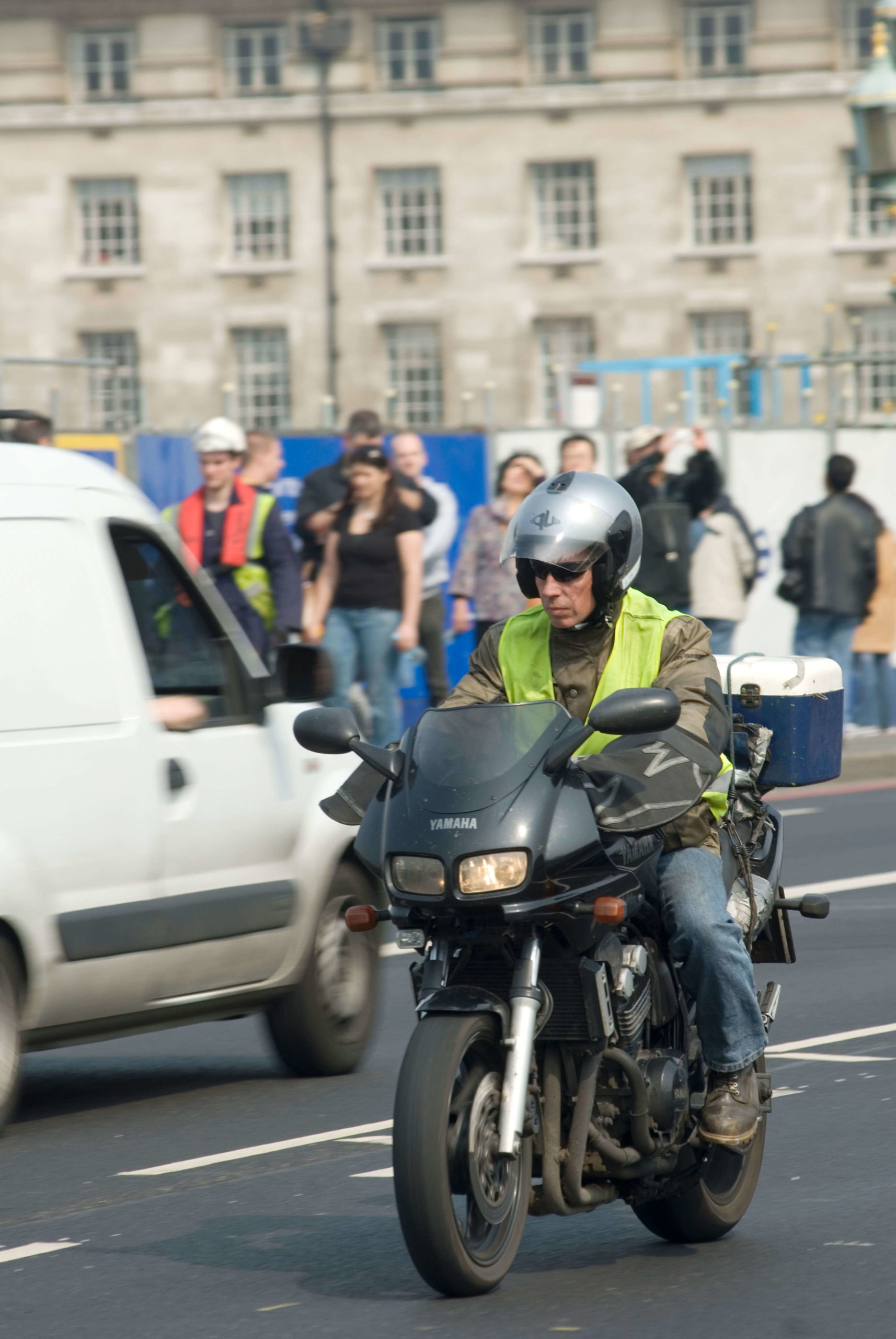 Motorcycle courier traveling in London traffic, England